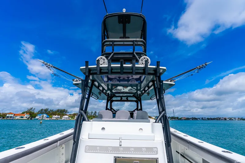 Slide: The Image of 2019 Yellowfin 42 Offshore boat on clear blue water under a vibrant sky. - 48