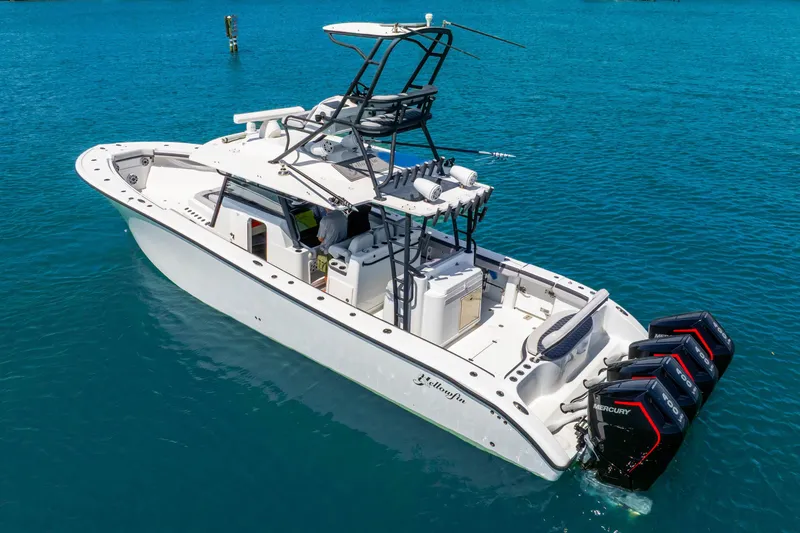 Slide: The Image of 2019 Yellowfin 42 Offshore boat with triple Mercury engines on blue water. - 5