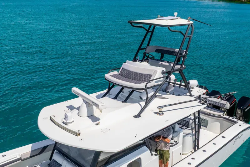 Slide: The Image of 2019 Yellowfin 42 Offshore boat on clear blue water, featuring elevated seating and advanced equipment. - 6