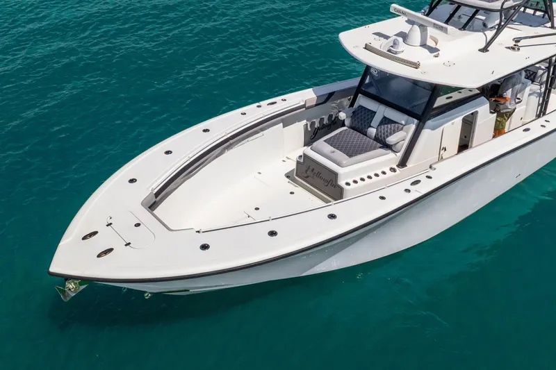 Slide: The Image of 2019 Yellowfin 42 Offshore boat on clear blue water, showcasing sleek design and spacious deck. - 7