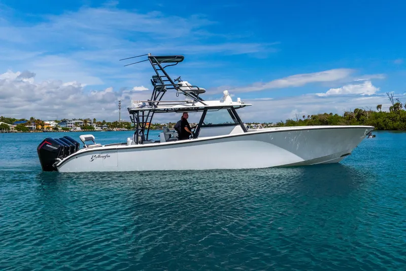 Slide: The Image of 2019 Yellowfin 42 Offshore boat cruising on clear blue water under a sunny sky. - 8