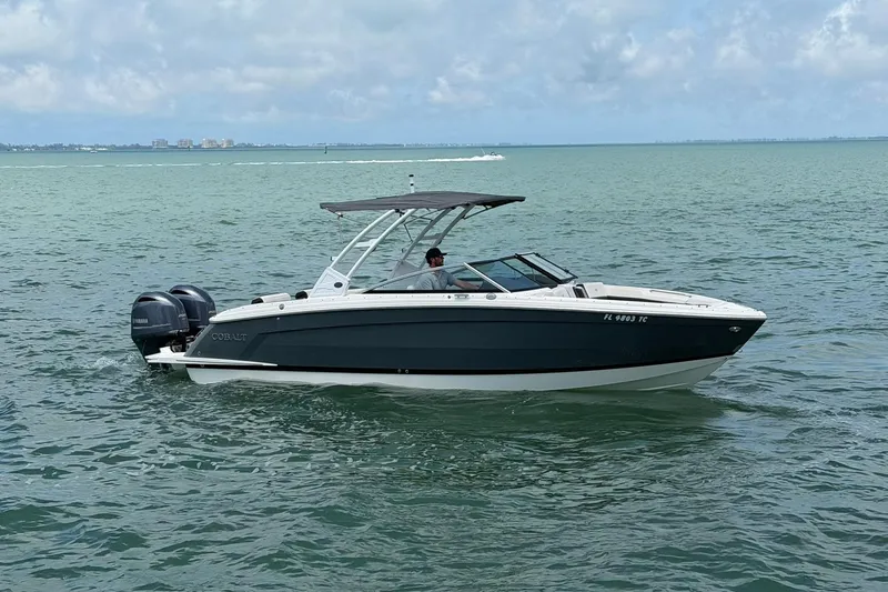 The Image of 2022 Cobalt R8 Outboard boat cruising on open water under a cloudy sky. - 0