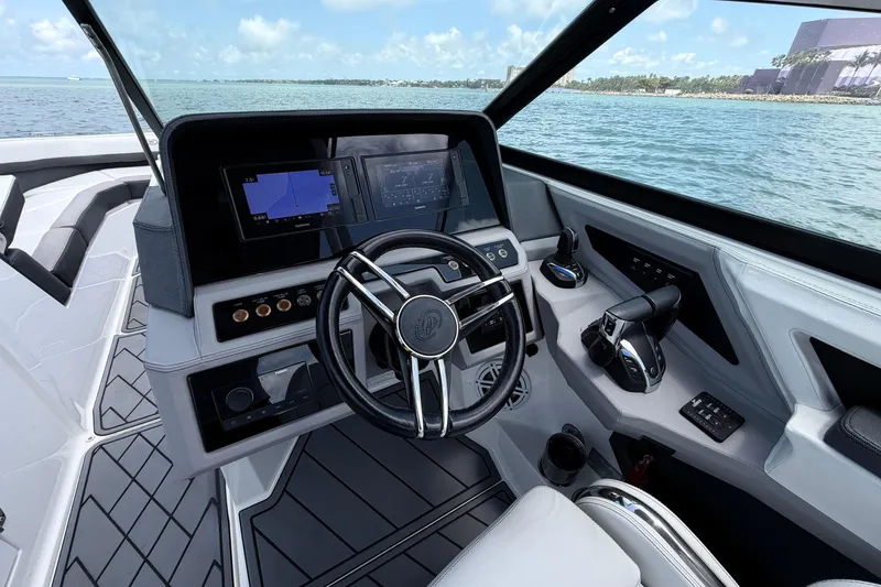 Slide: The Image of 2022 Cobalt R8 Outboard boat cockpit with modern controls and navigation screens. - 10
