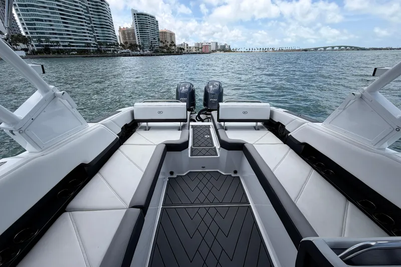 Slide: The Image of 2022 Cobalt R8 Outboard boat interior with city skyline and ocean view. - 11