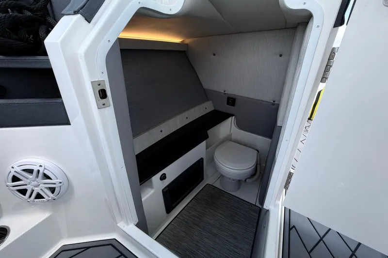 Slide: The Image of 2022 Cobalt R8 Outboard boat interior with compact bathroom and modern design. - 14