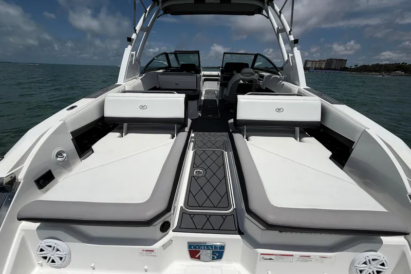 Slide: The Image of 2022 Cobalt R8 Outboard boat interior with spacious seating and sleek design on open water. - 16