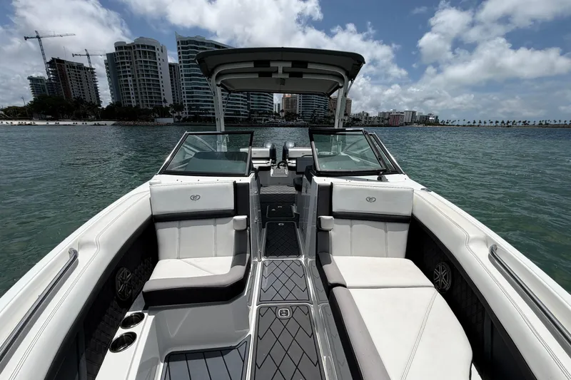 Slide: The Image of 2022 Cobalt R8 Outboard boat interior with city skyline and ocean view. - 7