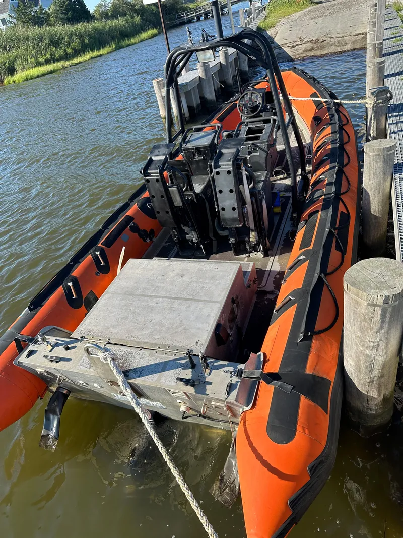 Slide: The Image of Orange Zodiac 24 boat docked by the shore, 2008 model. - 5