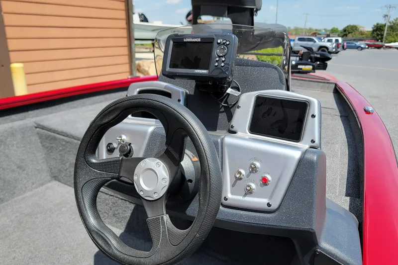Slide: The Image of 2025 Tracker Pro Team 175 boat dashboard with steering wheel and electronic displays. - 3