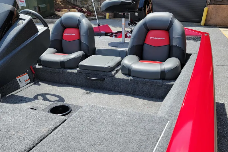 Slide: The Image of 2025 Tracker Pro Team 175 boat interior with red and black seating. - 8