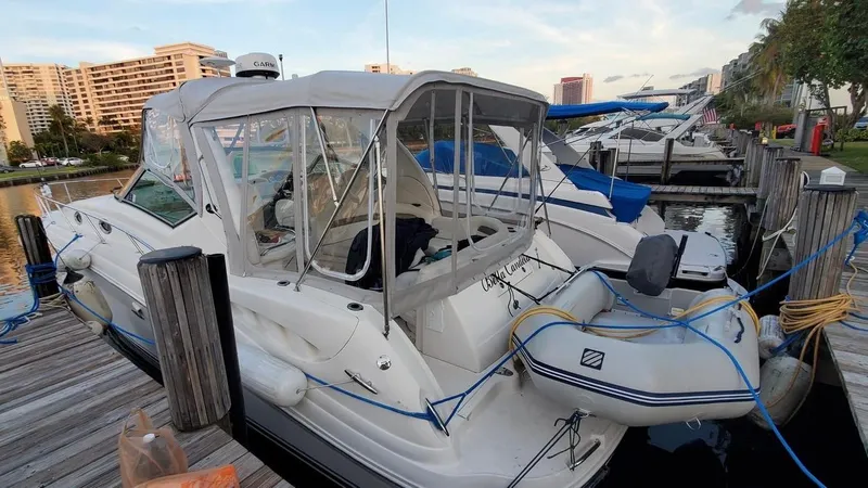 Slide: The Image of 2006 Sea Ray 340 Sundancer docked with inflatable boat, marina background. - 22
