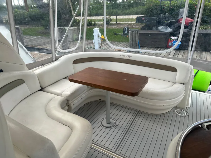 Slide: The Image of 2006 Sea Ray 340 Sundancer interior seating area with wooden table. - 34