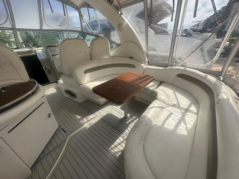 Slide: The Image of 2006 Sea Ray 340 Sundancer interior with white seating and wooden table. - 37