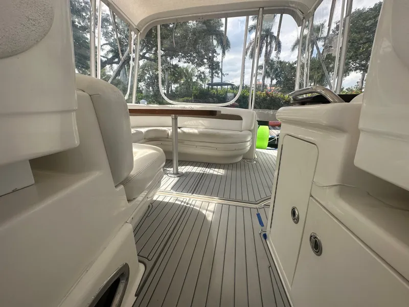 Slide: The Image of Interior of a 2006 Sea Ray 340 Sundancer yacht with white seating and table. - 43