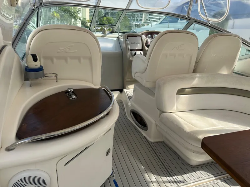 Slide: The Image of Interior of 2006 Sea Ray 340 Sundancer yacht with white seating and wooden accents. - 46