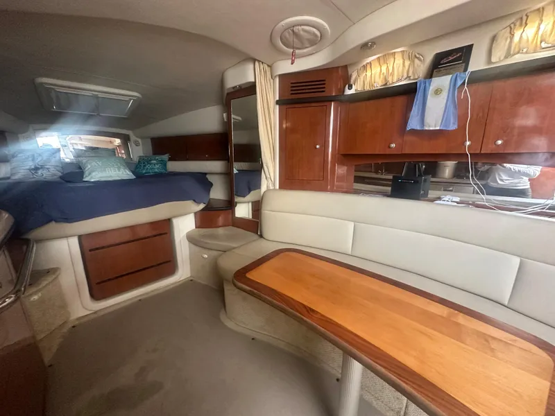 Slide: The Image of Interior of a 2006 Sea Ray 340 Sundancer yacht with seating, table, and bed. - 53