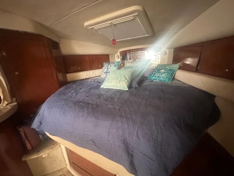 Slide: The Image of 2006 Sea Ray 340 Sundancer cabin with cozy bed and decorative pillows. - 56