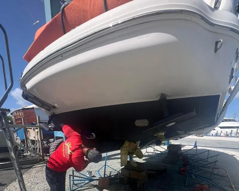 Slide: The Image of Mechanic working on 2006 Sea Ray 340 Sundancer boat hull in a shipyard. - 59