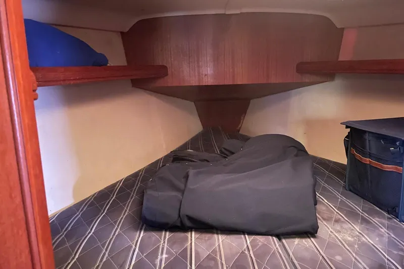 Slide: The Image of Interior cabin of a 2006 Hunter 36 sailboat with storage shelves and bedding. - 10