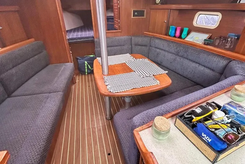 Slide: The Image of Interior of a 2006 Hunter 36 sailboat with cozy seating and wooden accents. - 5