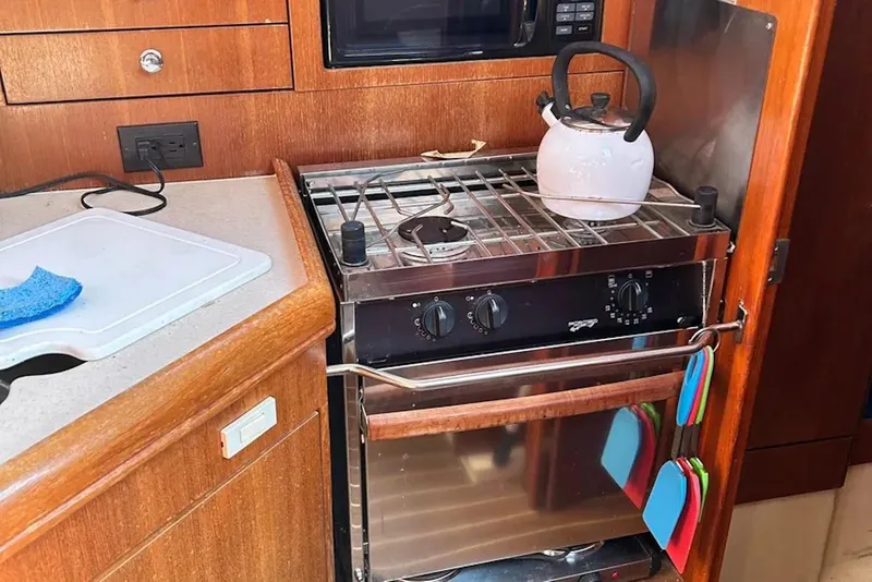 Slide: The Image of Compact kitchen area in a 2006 Hunter 36 yacht with stove and kettle. - 8