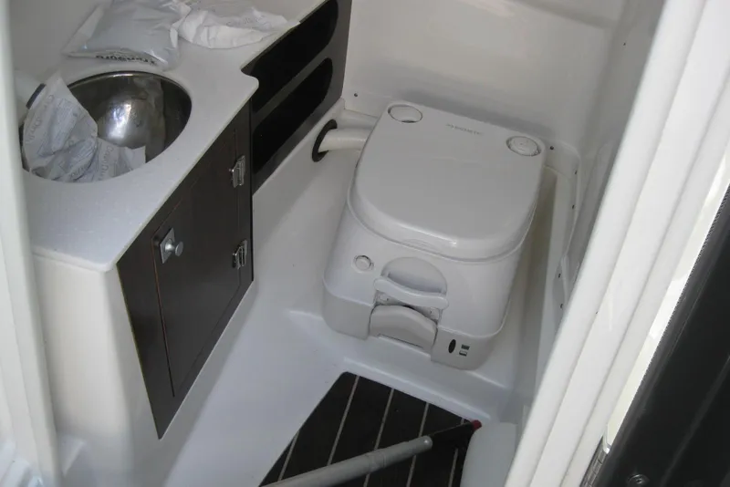 Slide: The Image of Interior of 2018 Monterey 278SS Super Sport boat with compact bathroom amenities. - 17