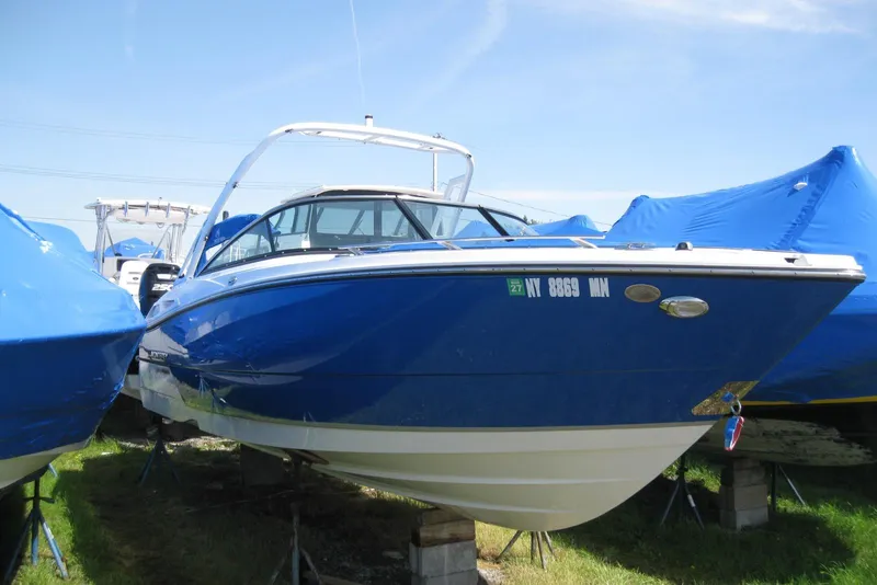 Slide: The Image of 2018 Monterey 278SS Super Sport boat in blue, docked on land. - 2