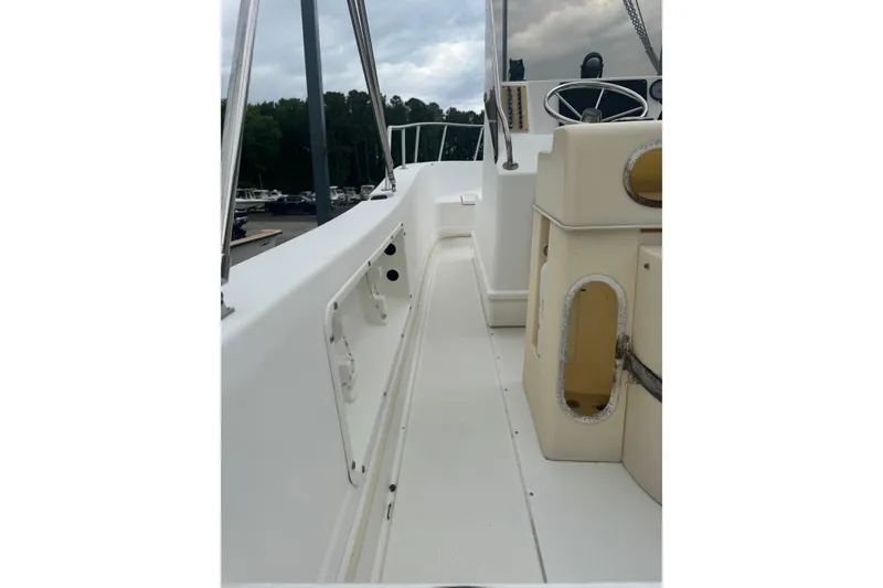 Slide: The Image of 1997 Henry O 199 boat deck with steering wheel and storage compartments. - 4