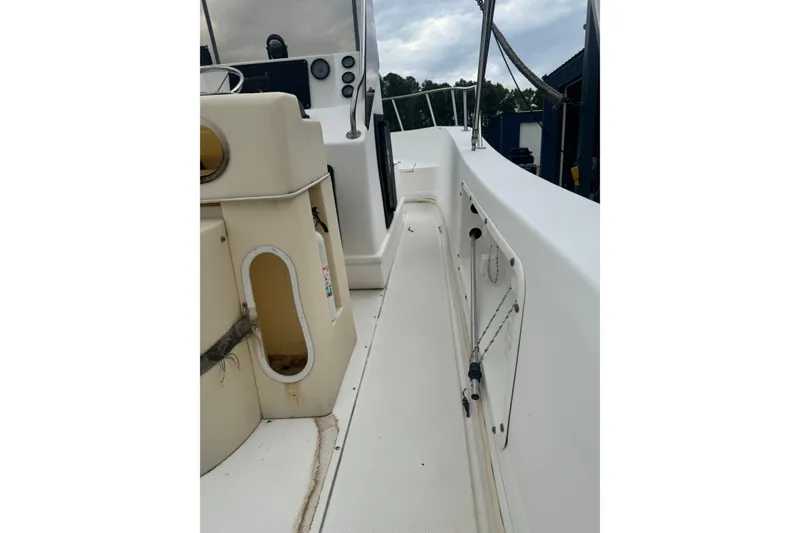Slide: The Image of Interior view of a 1997 Henry O 199 boat, showcasing seating and storage areas. - 5