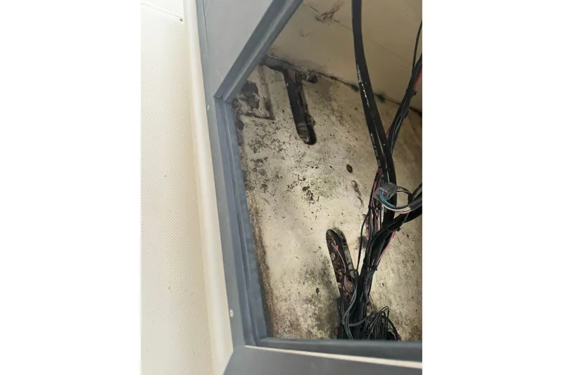 Slide: The Image of Interior view of a 1997 Henry O 199 boat showing wiring and storage area. - 6