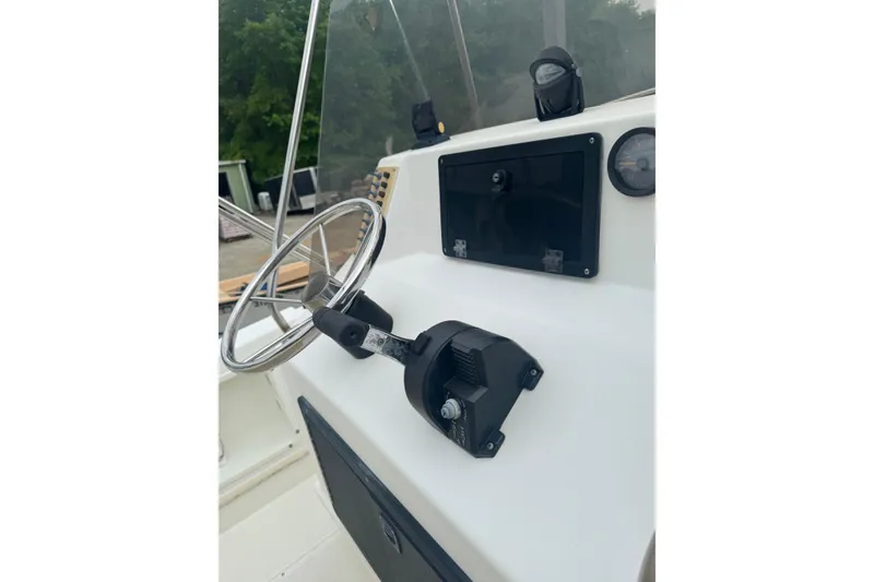 Slide: The Image of Steering console of a 1997 Henry O 199 boat with controls and gauges. - 7