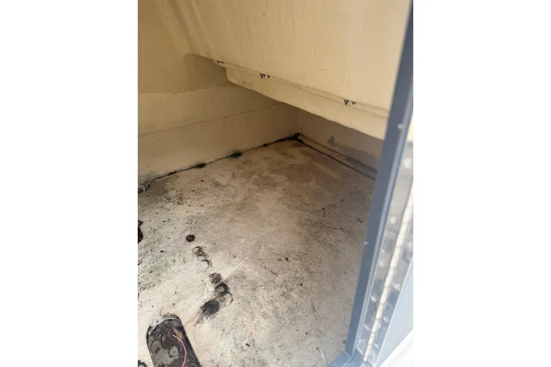 Slide: The Image of Empty storage compartment in a 1997 Henry O model 199 boat. - 8