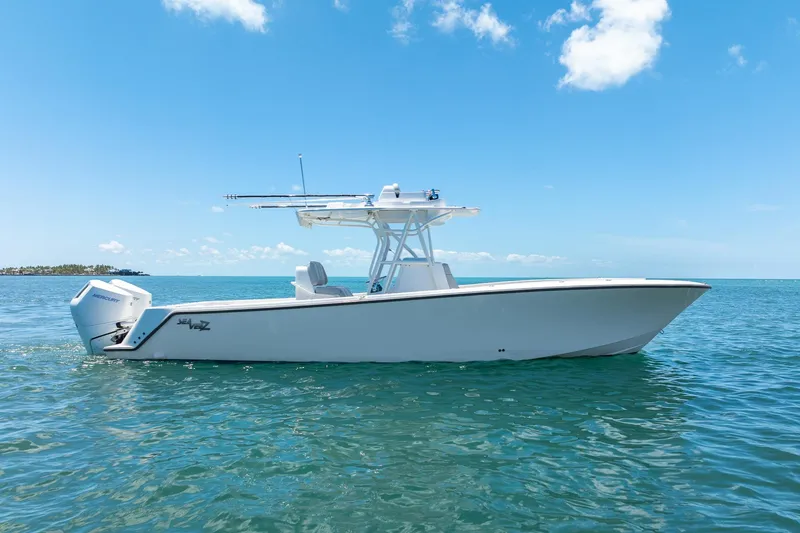 The Image of 2025 SeaVee 322Z boat on clear blue water under a sunny sky. - 0