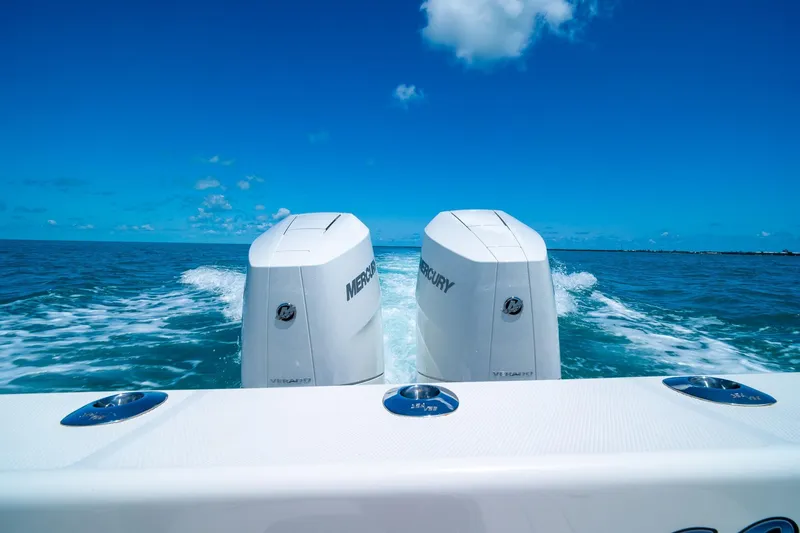 Slide: The Image of Twin Mercury engines on a 2025 SeaVee 322Z boat cruising in clear blue ocean. - 11