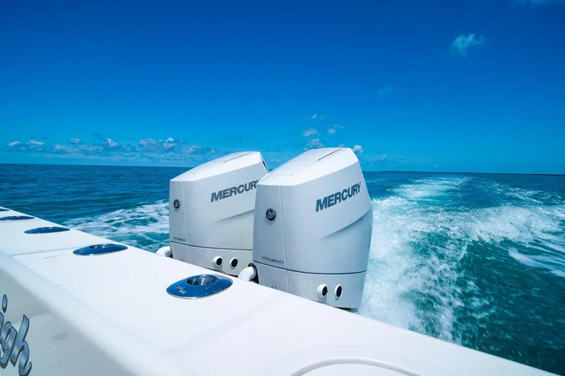 Slide: The Image of 2025 SeaVee 322Z boat with twin Mercury engines cruising on open water. - 12