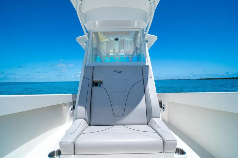 Slide: The Image of 2025 SeaVee 322Z boat with sleek seating, ocean backdrop, and clear blue sky. - 17