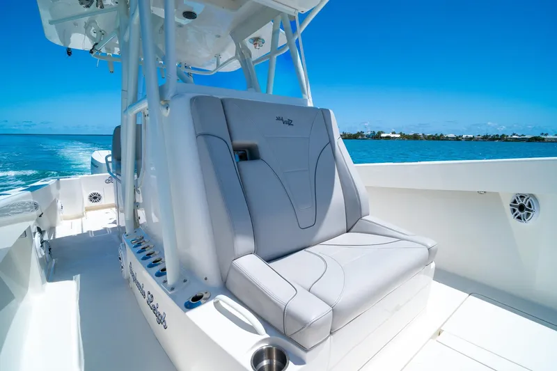 Slide: The Image of 2025 SeaVee 322Z boat interior with sleek seating, cruising on clear blue waters. - 18
