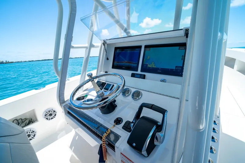 Slide: The Image of 2025 SeaVee 322Z boat helm with modern navigation screens and controls. - 19