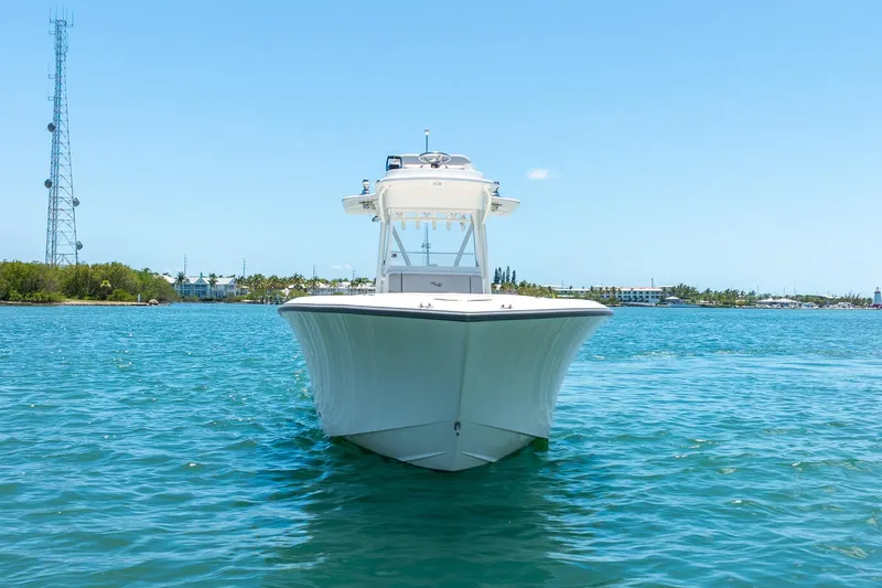 Slide: The Image of 2025 SeaVee 322Z boat on clear blue water, front view. - 2