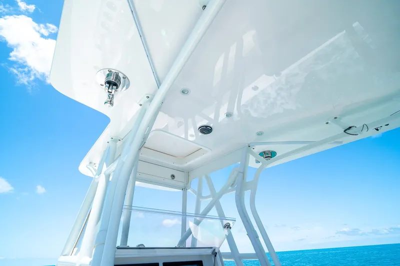Slide: The Image of 2025 SeaVee 322Z boat's T-top against a clear blue sky and ocean backdrop. - 23