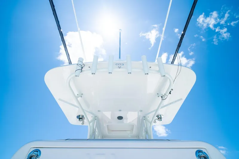 Slide: The Image of SeaVee 322Z 2025 boat tower against a bright blue sky with clouds. - 28