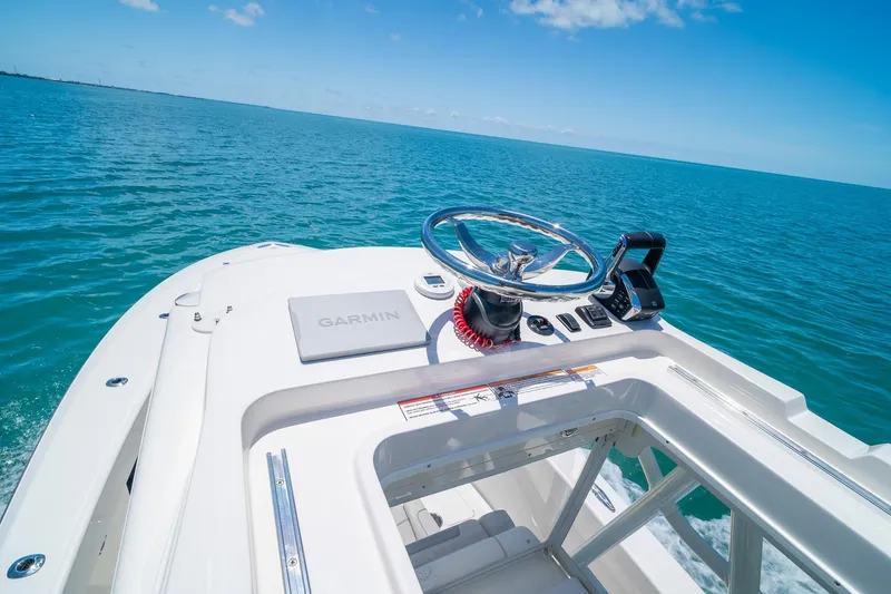Slide: The Image of 2025 SeaVee 322Z boat helm with Garmin navigation on open ocean. - 32