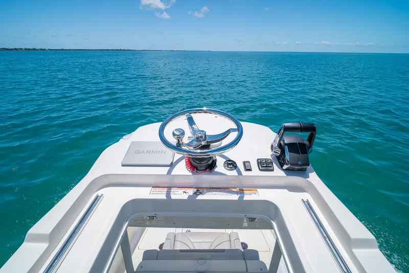 Slide: The Image of Helm of 2025 SeaVee 322Z boat with Garmin equipment, overlooking calm ocean waters. - 33
