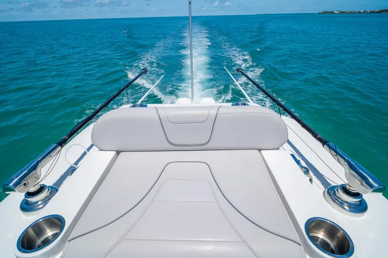 Slide: The Image of 2025 SeaVee 322Z boat cruising on open water, featuring fishing rods and comfortable seating. - 35
