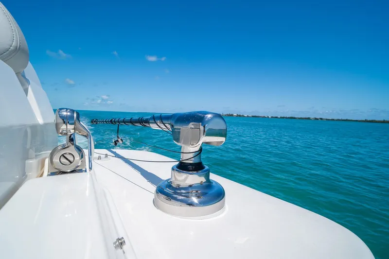Slide: The Image of 2025 SeaVee 322Z boat on clear blue water, showcasing sleek design and chrome details. - 36