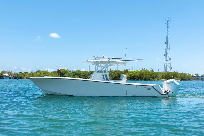 Slide: The Image of 2025 SeaVee 322Z boat on clear blue water under a sunny sky. - 4