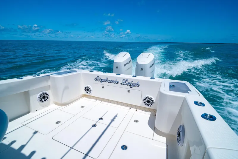 Slide: The Image of 2025 SeaVee 322Z boat cruising on open water with twin Mercury engines. - 9