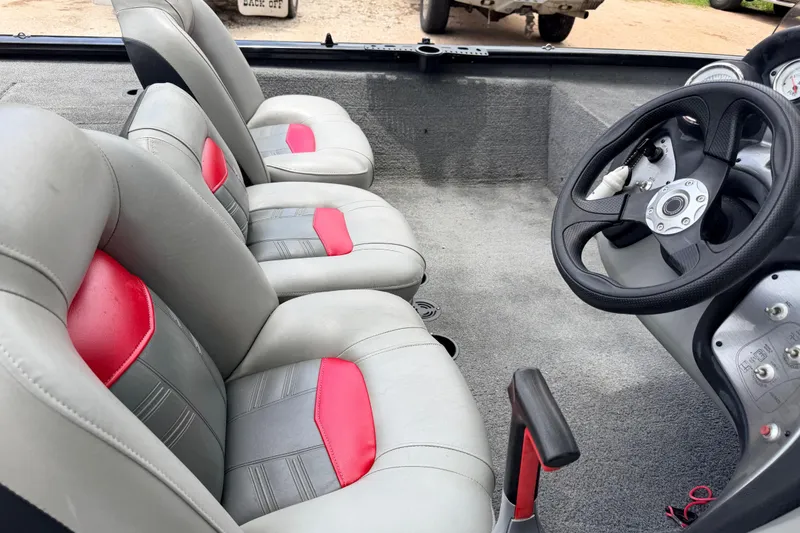 Slide: The Image of Interior of a 2017 Tracker Pro Team 175 TXW boat with gray and red seating. - 10