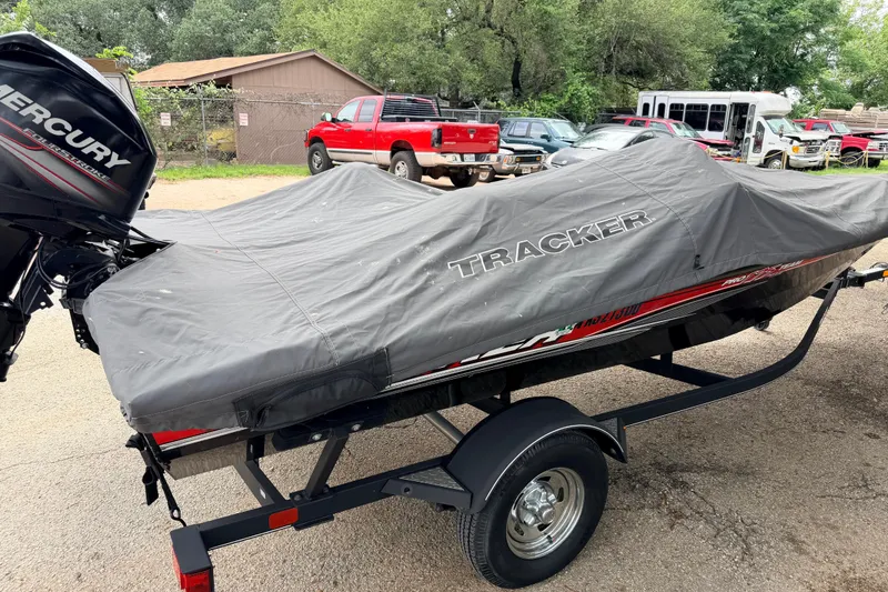 Slide: The Image of 2017 Tracker Pro Team 175 TXW boat covered on trailer, parked outdoors. - 14