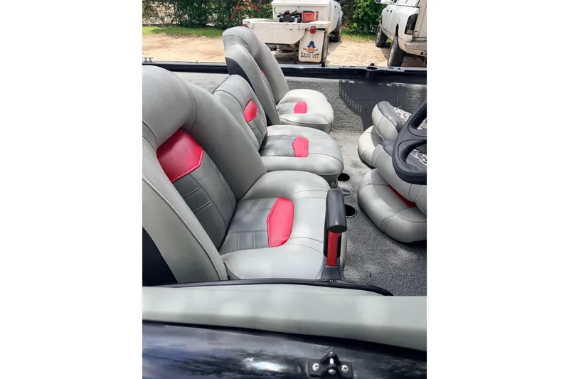 Slide: The Image of 2017 Tracker Pro Team 175 TXW boat interior with gray and red seats. - 5